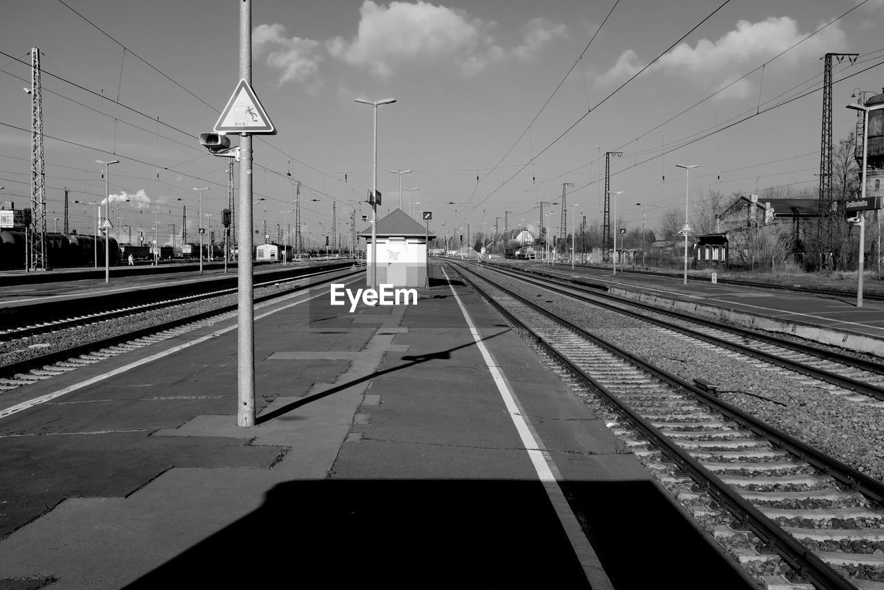 TRAIN ON RAILROAD TRACKS AGAINST SKY