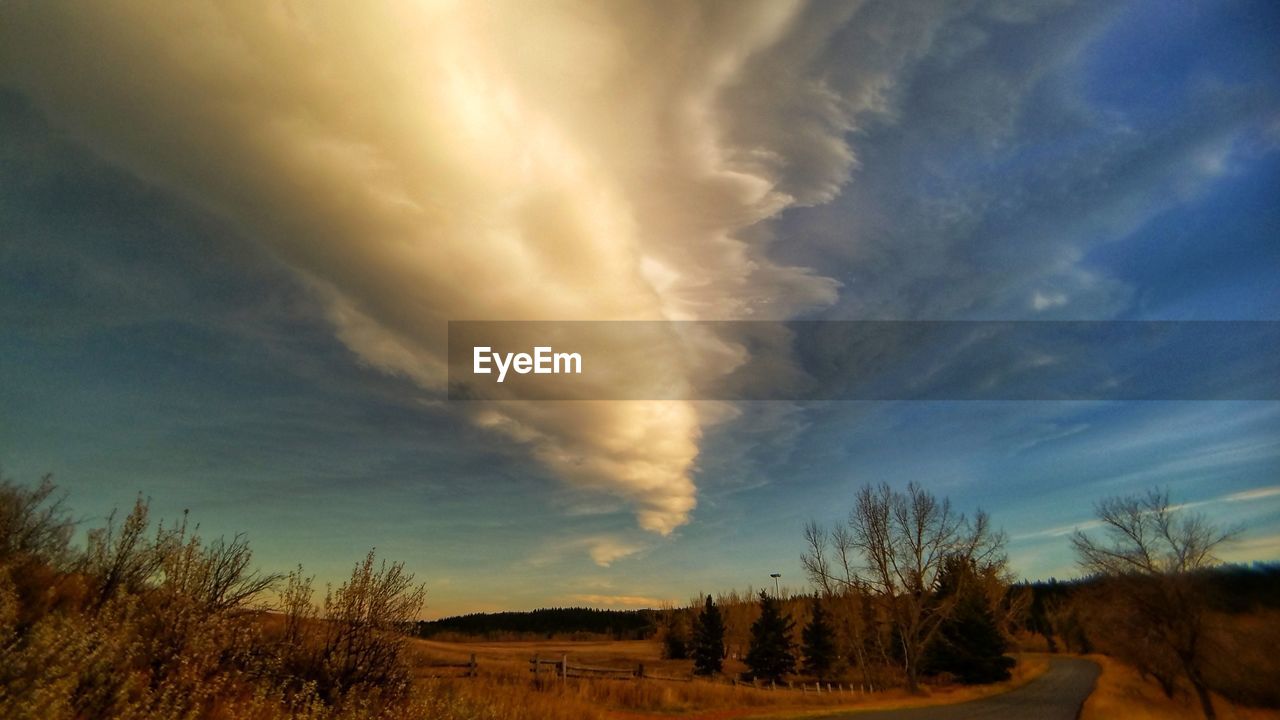 STORM CLOUDS OVER LANDSCAPE AGAINST SKY