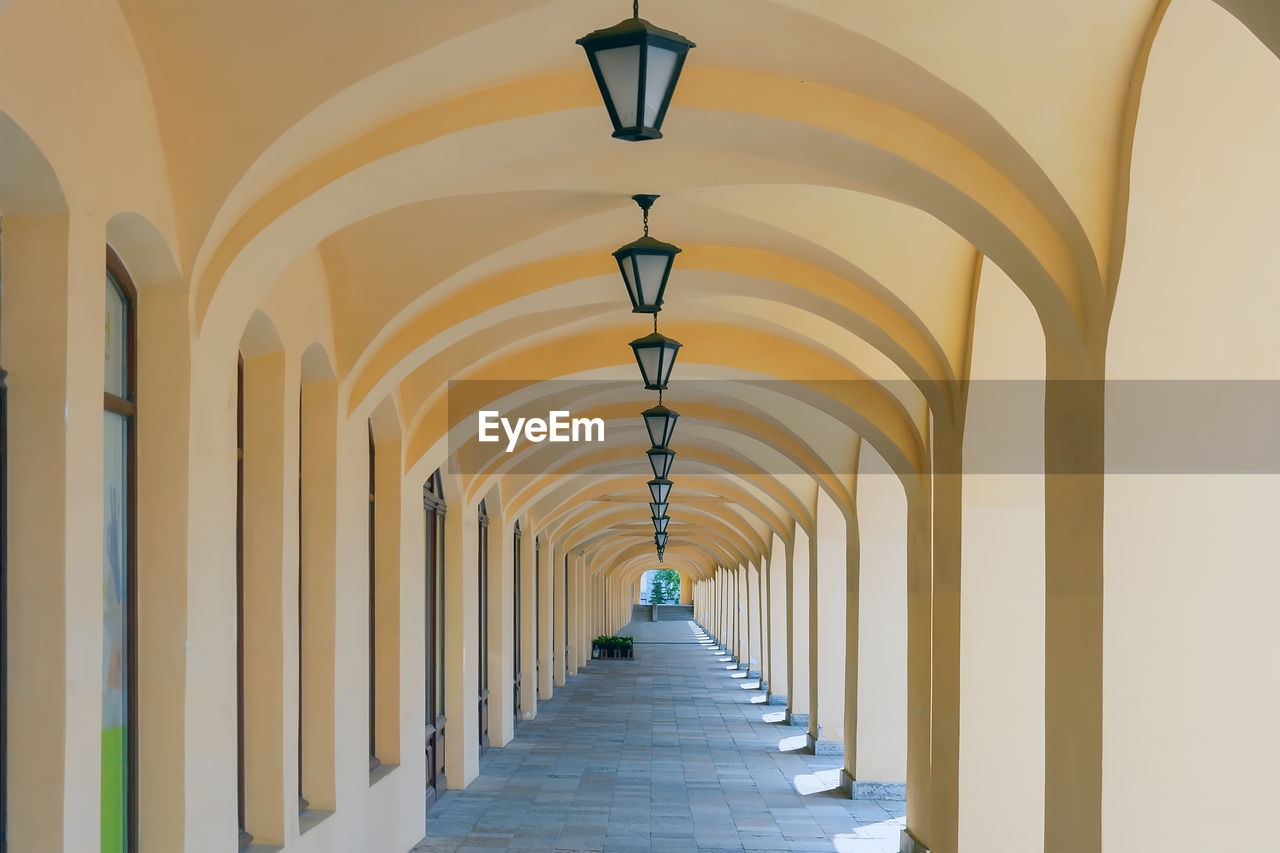 Arched colonnade with hanging lanterns. perspective. summer. day