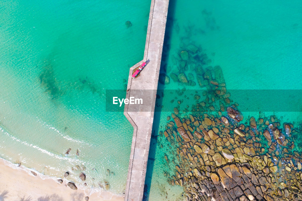 HIGH ANGLE VIEW OF SWIMMING POOL BY SEA