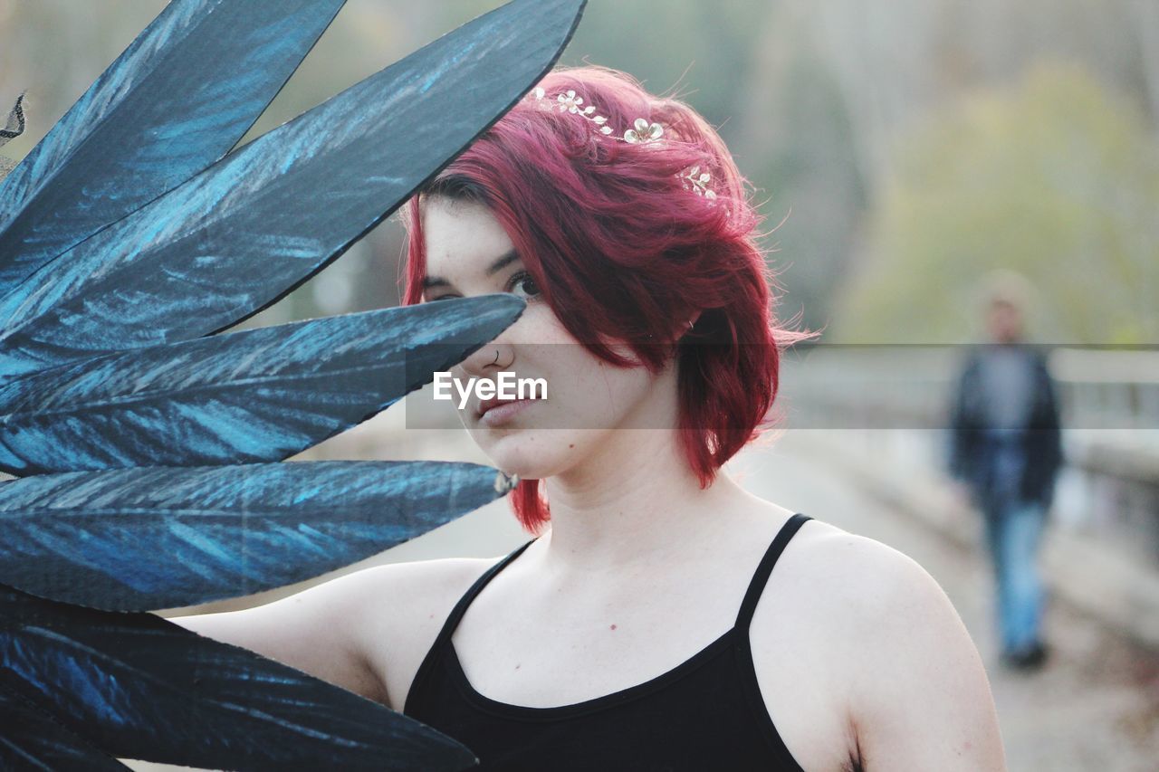 real people, portrait, lifestyles, one person, young women, women, headshot, young adult, redhead, dyed hair, leisure activity, focus on foreground, adult, beautiful woman, beauty, hairstyle, looking, front view, dyed red hair, outdoors, contemplation, teenager