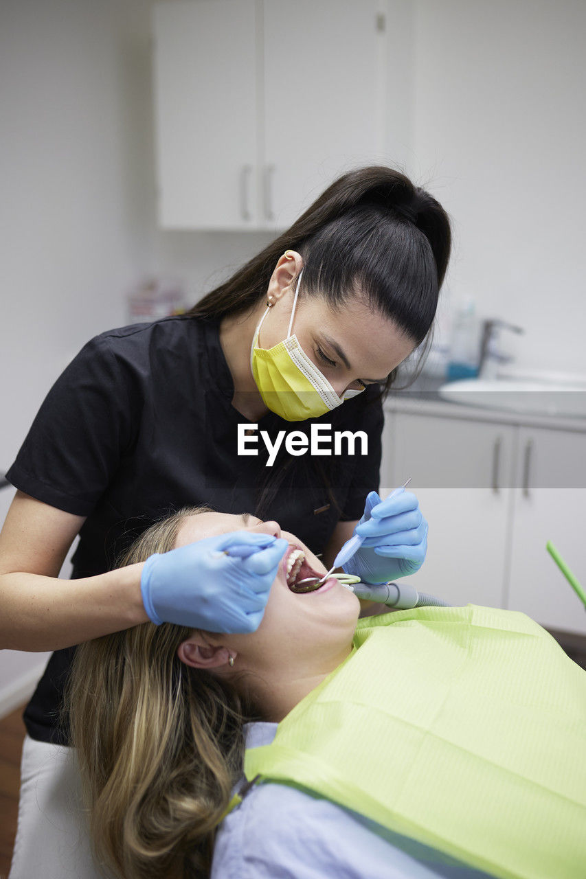 Female dentist with patient in office