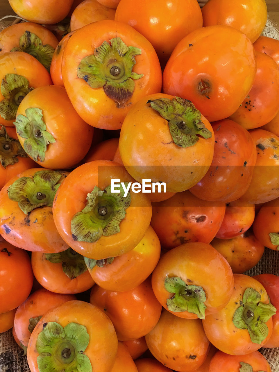 Full frame shot of persimmons for sale at market stall