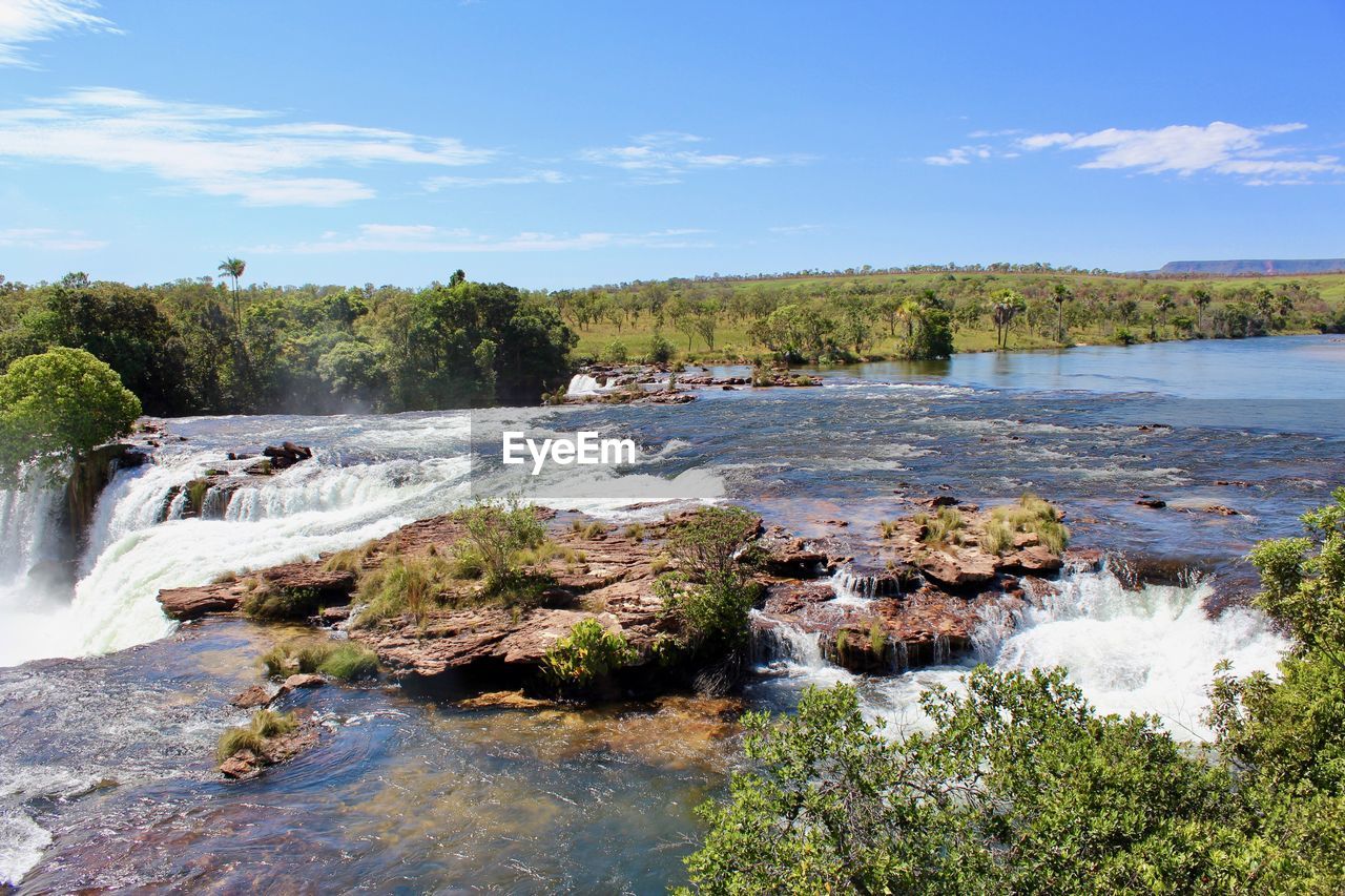 Scenic view of waterfall against sky