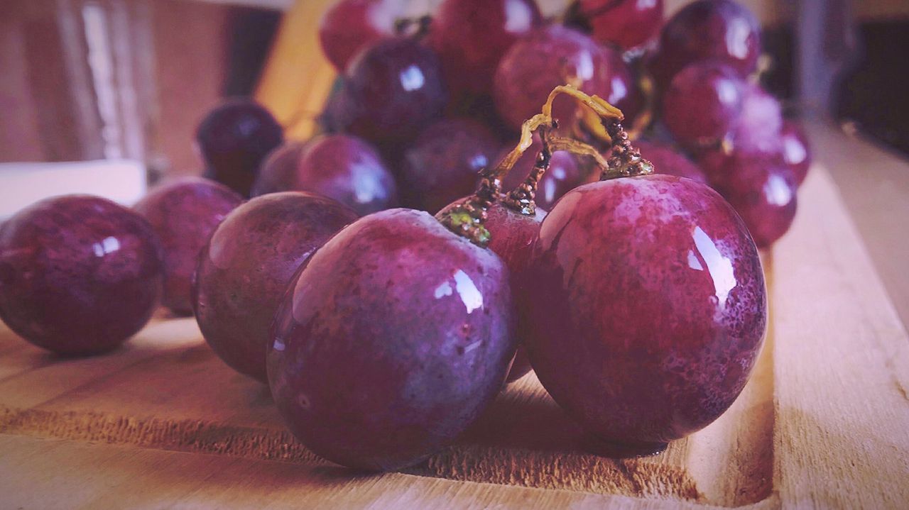 Close-up of wet grapes on table