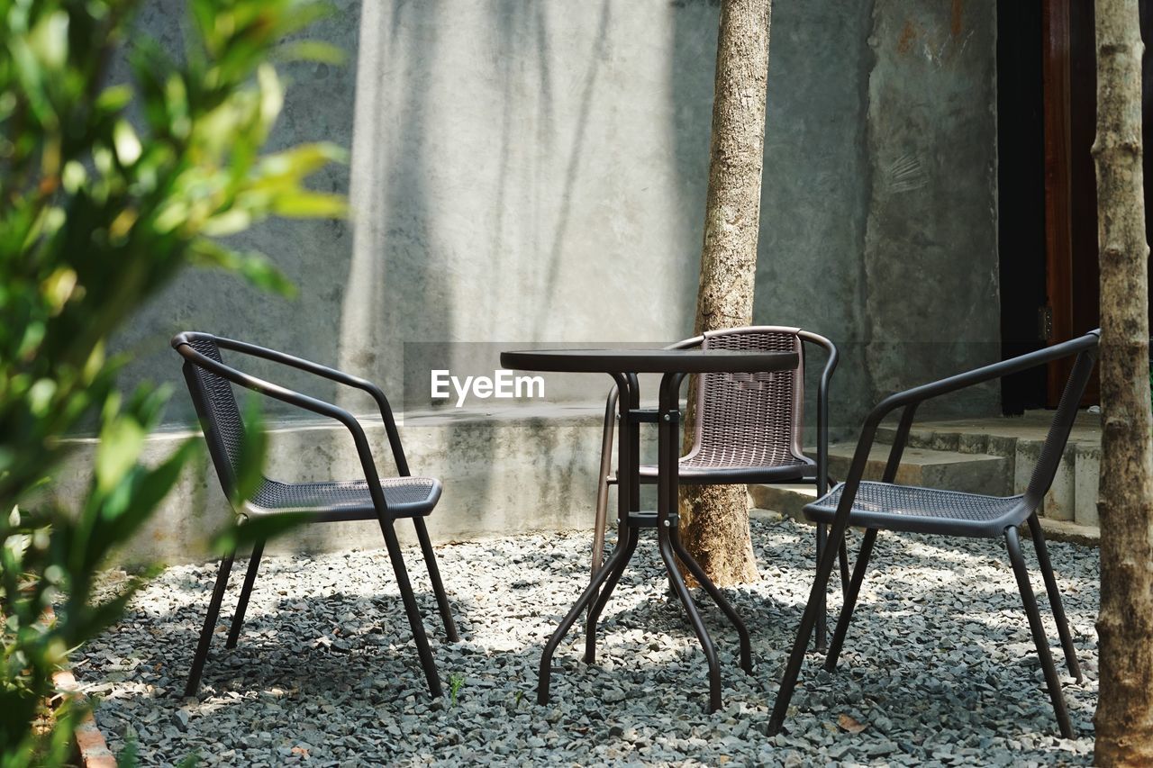 Empty chairs and table in park