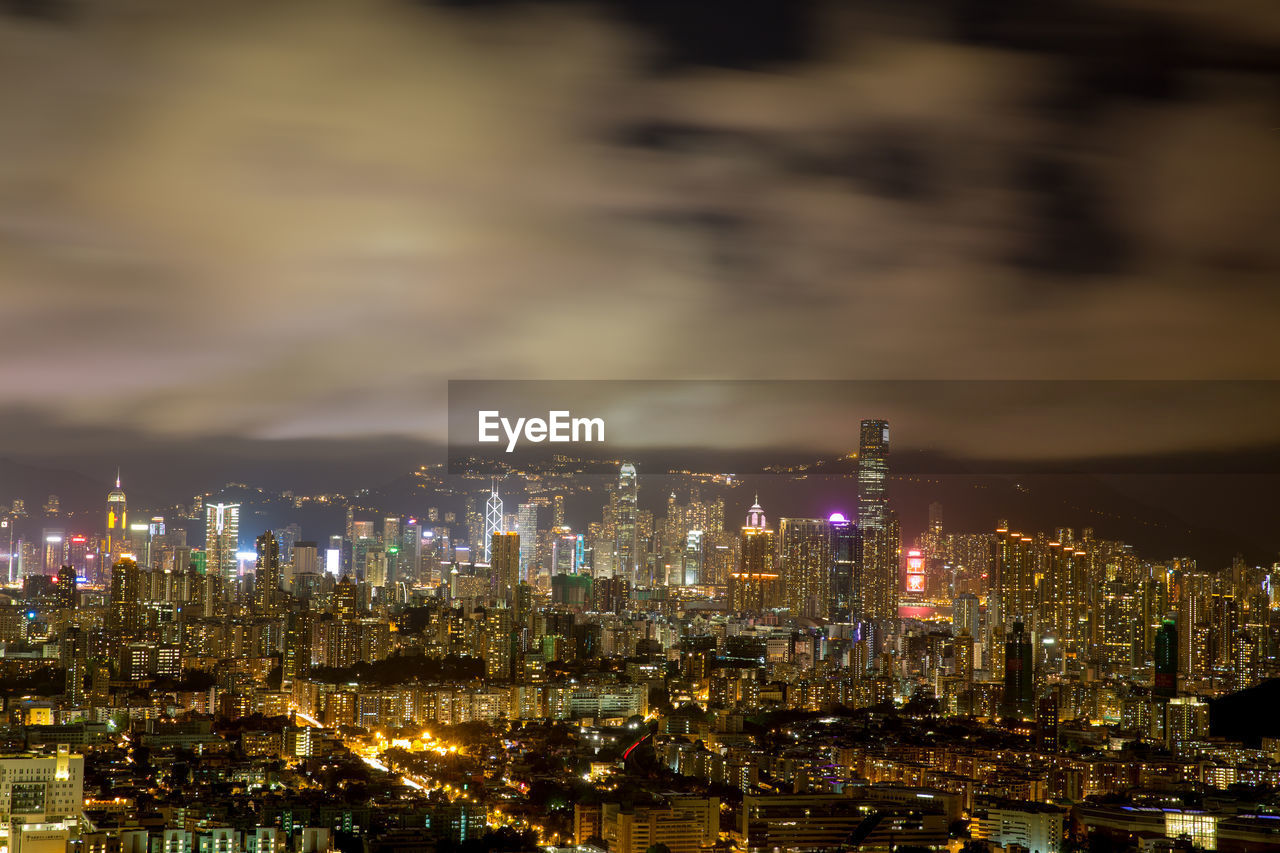 Illuminated cityscape against sky at night