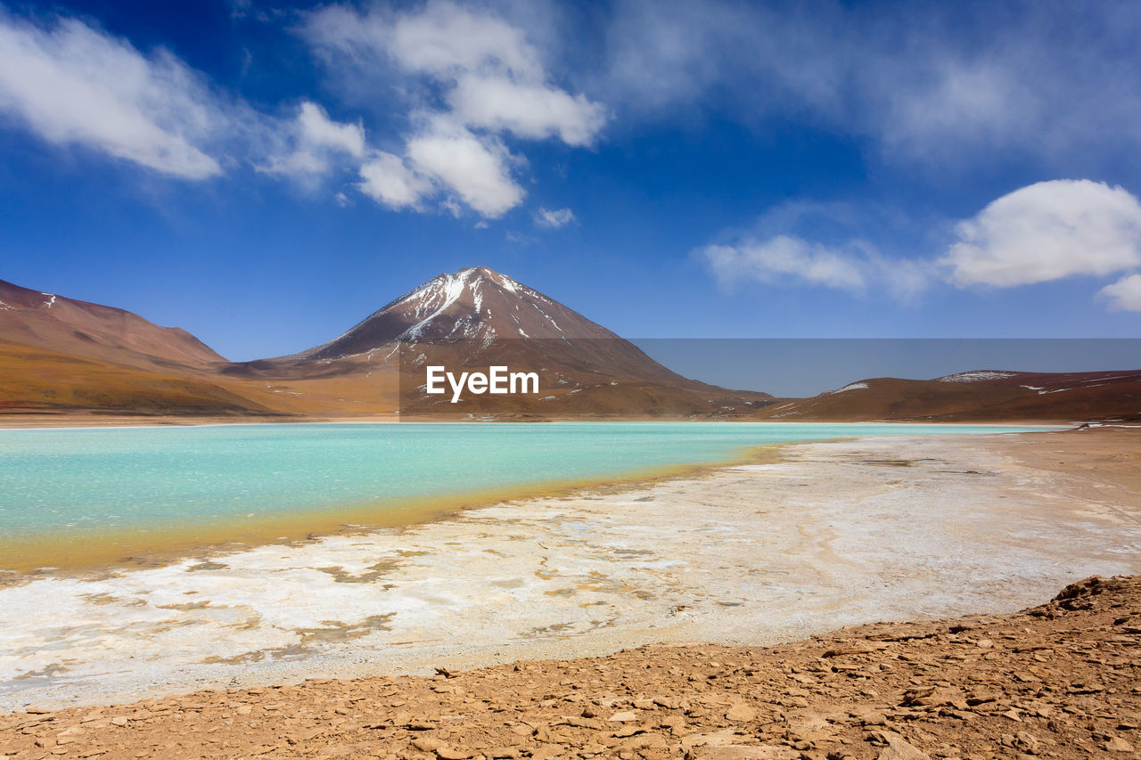 SCENIC VIEW OF BEACH AND MOUNTAINS AGAINST SKY