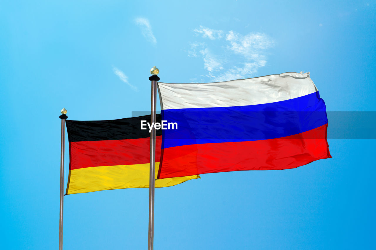 Flags against blue sky