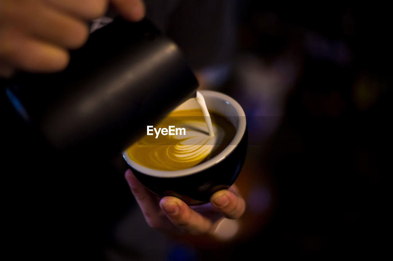 Close-up of person preparing coffee