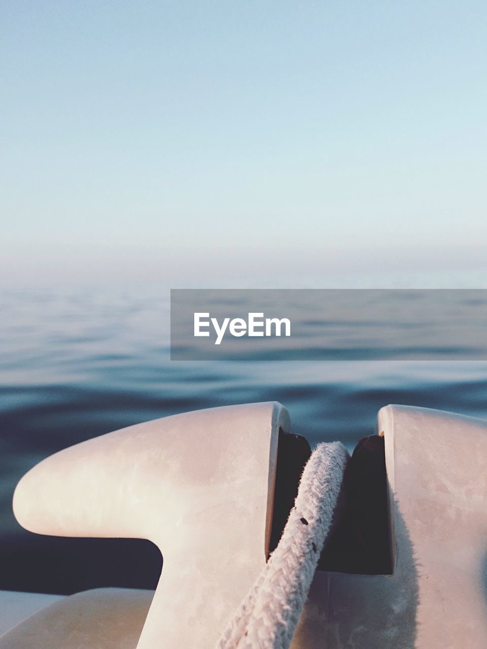 Close-up of rope on boat at sea against clear sky