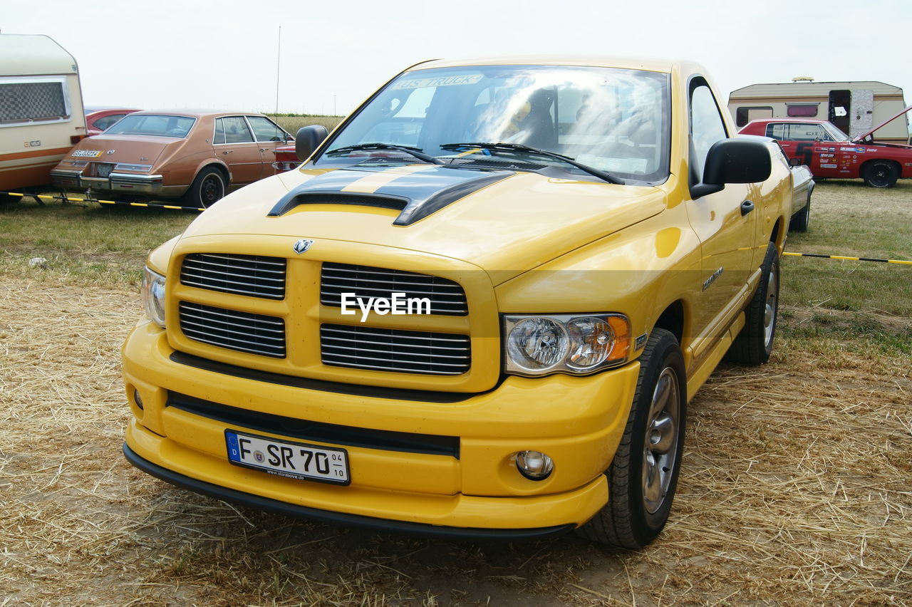 YELLOW CAR PARKED ON ROAD