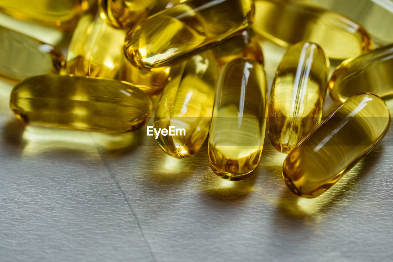 Close-up of cod liver oil capsules on table