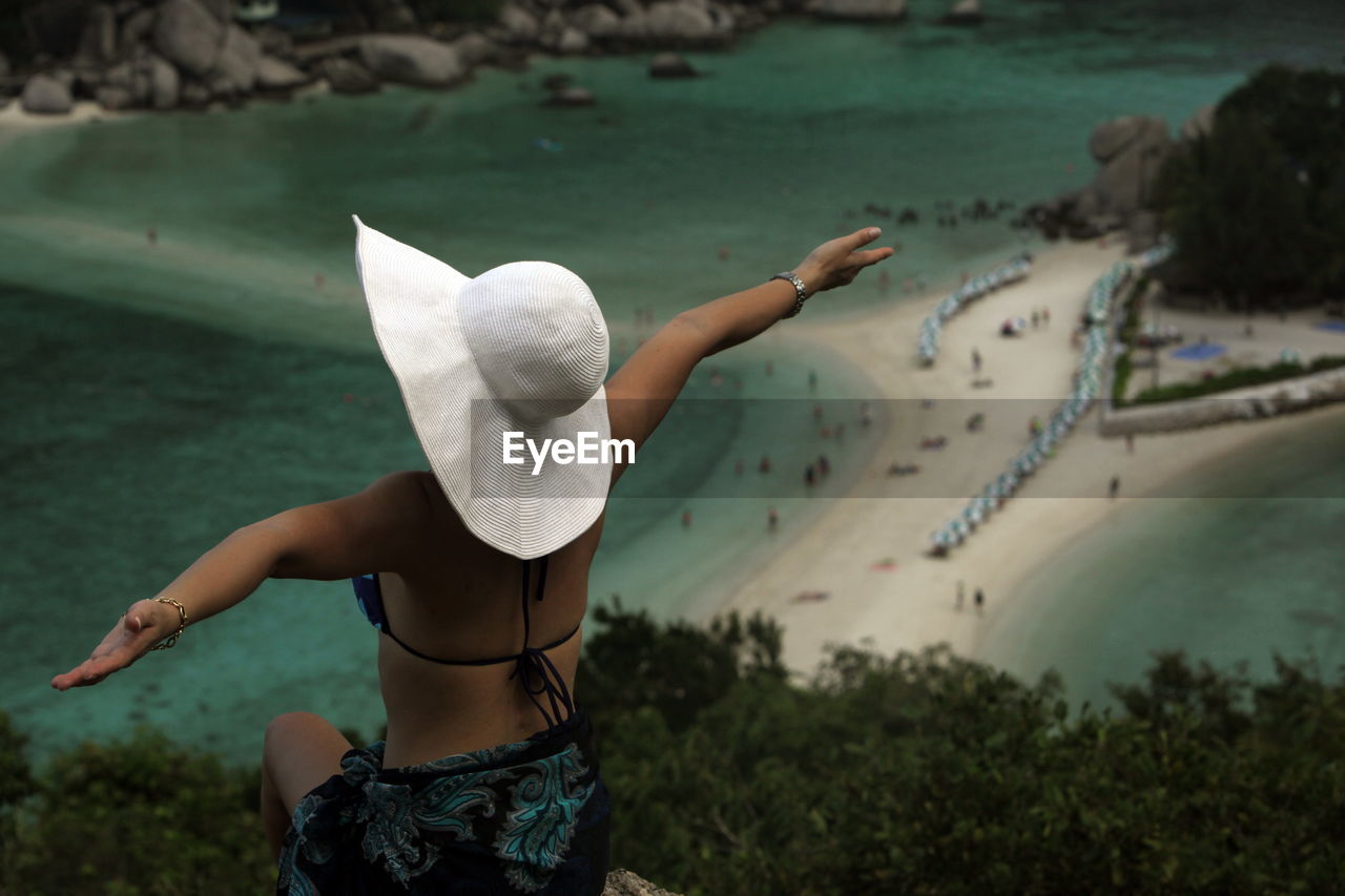 Rear view of woman looking at beach