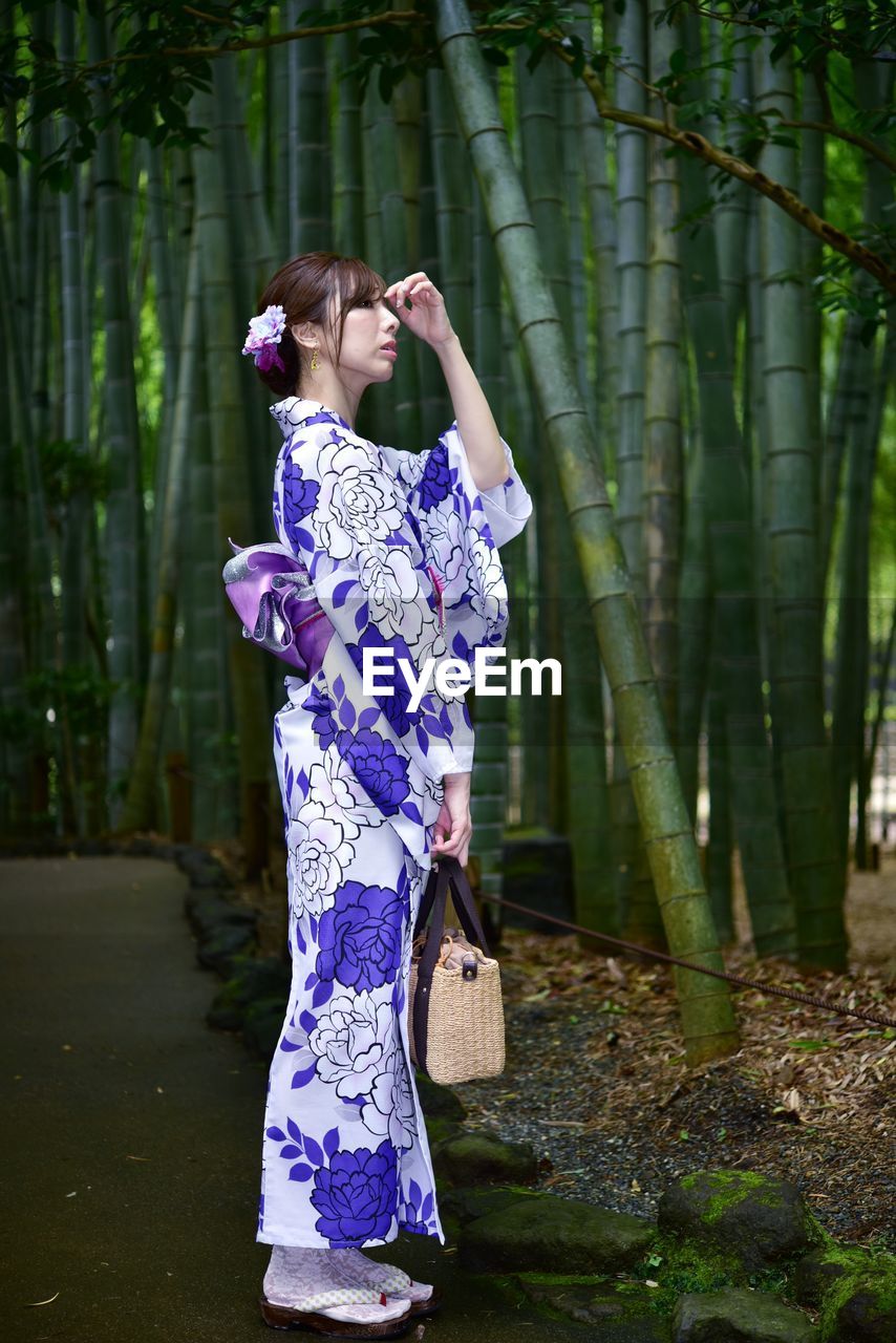 Midsection of woman standing on tree