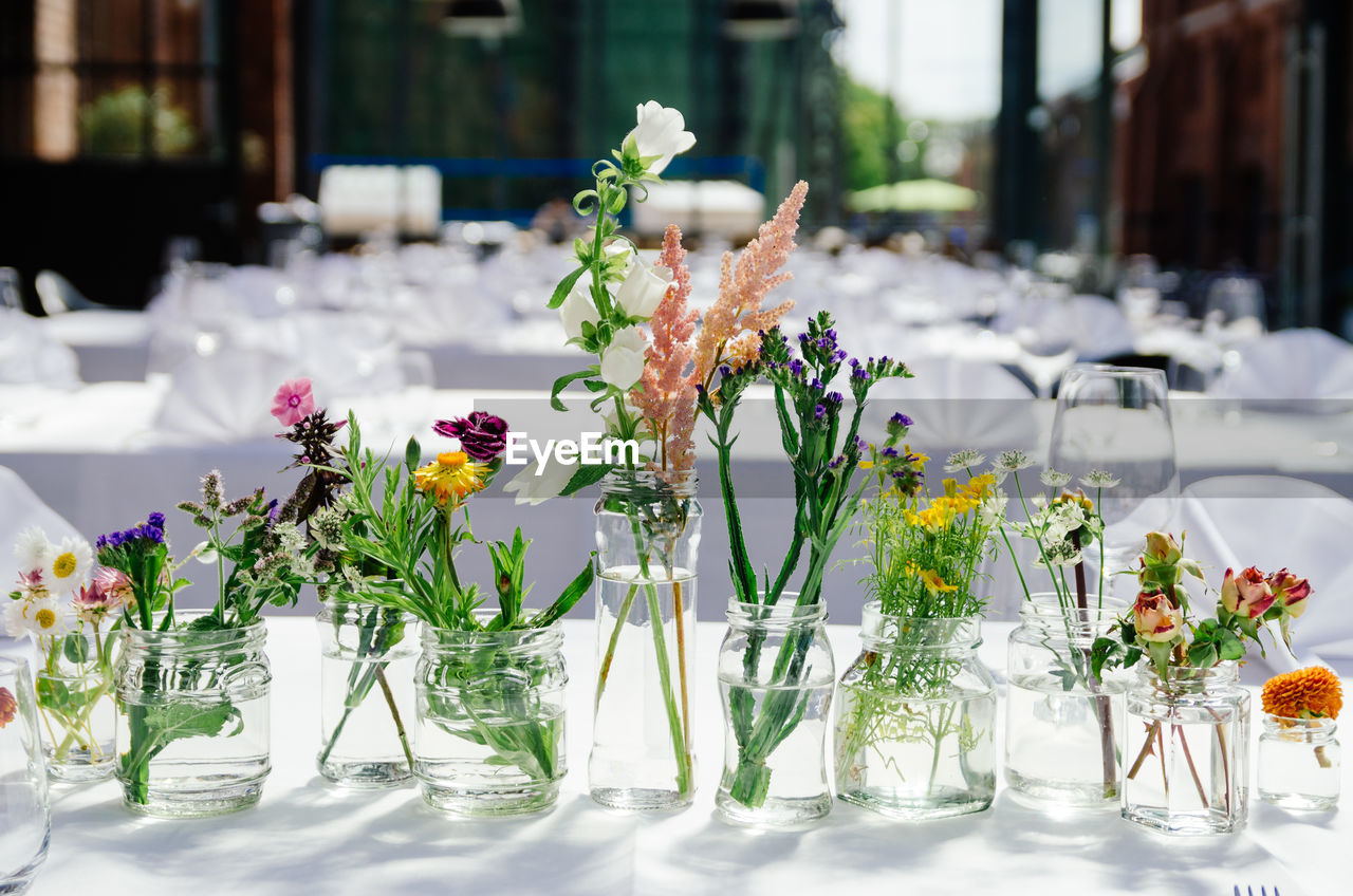 Various flower vases on table at restaurant