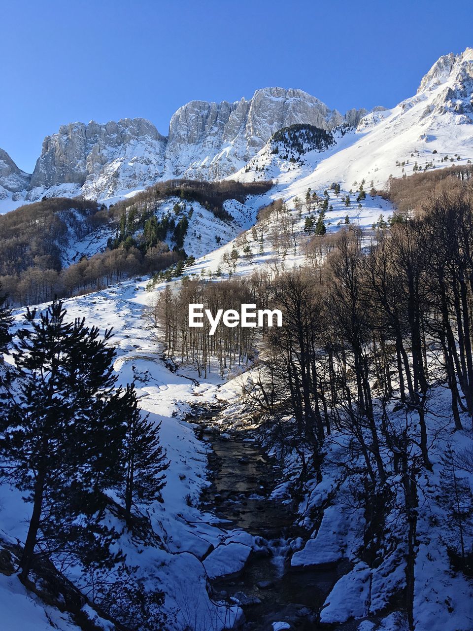 Scenic view of snowcapped mountains against clear sky