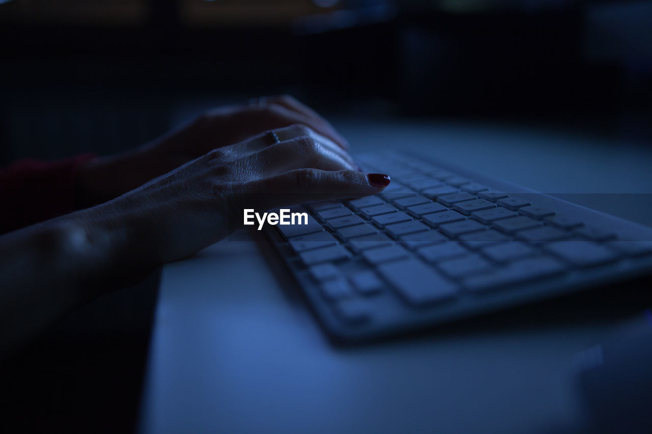 Close-up of woman using keyboard