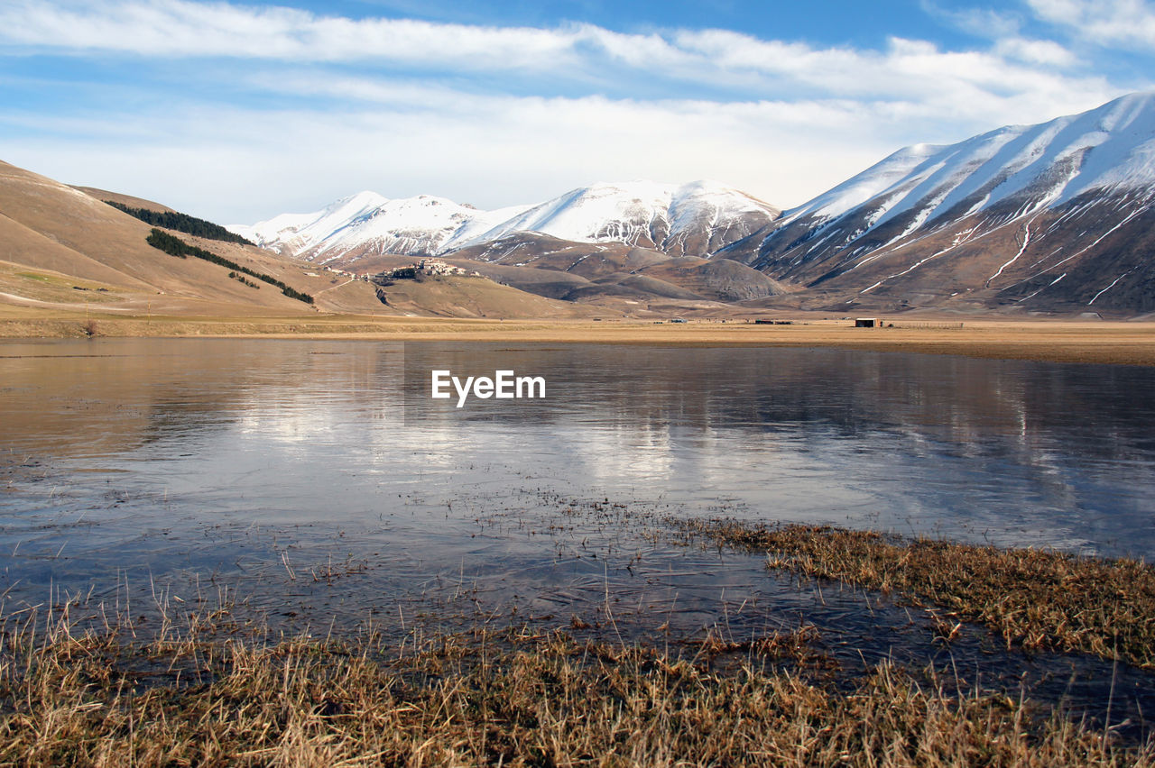 Scenic view of snowcapped mountains against sky