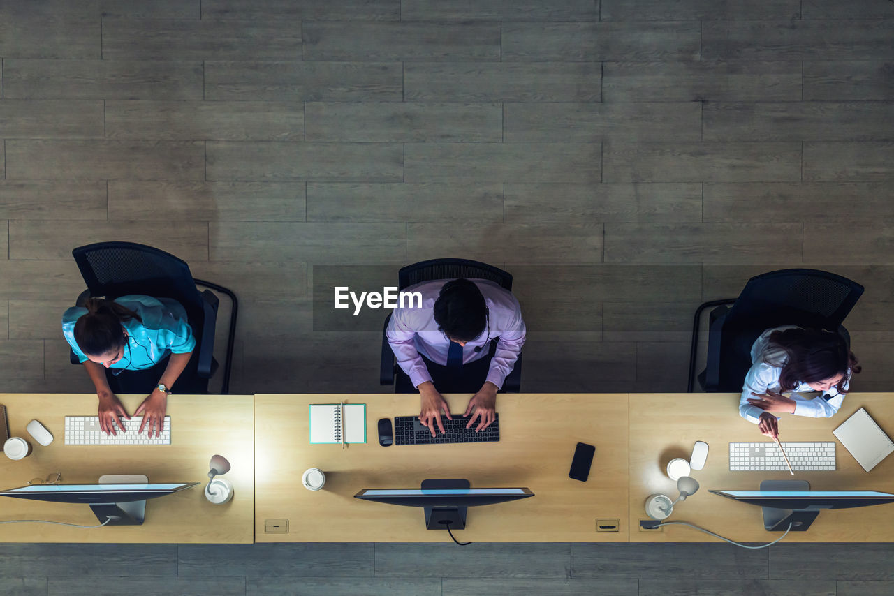 Directly above shot of people working at desk