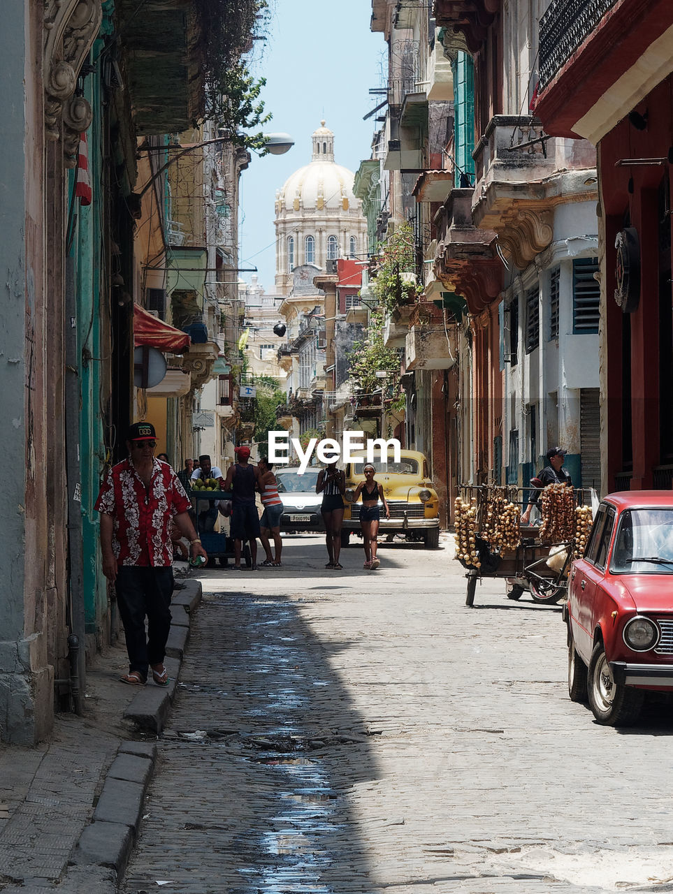 PEOPLE ON STREET AMIDST BUILDINGS