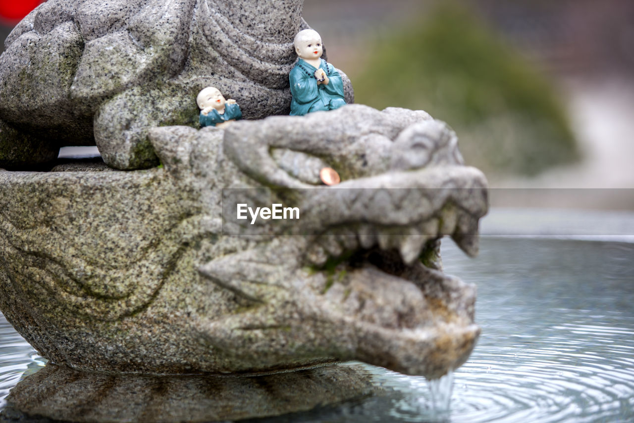 Figurines on sculpture in fountain