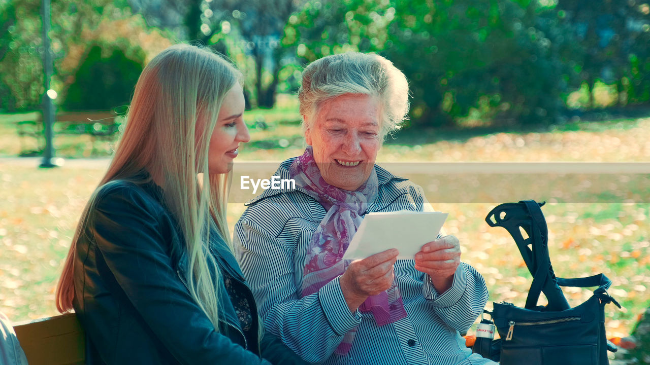 Man and woman using smart phone outdoors