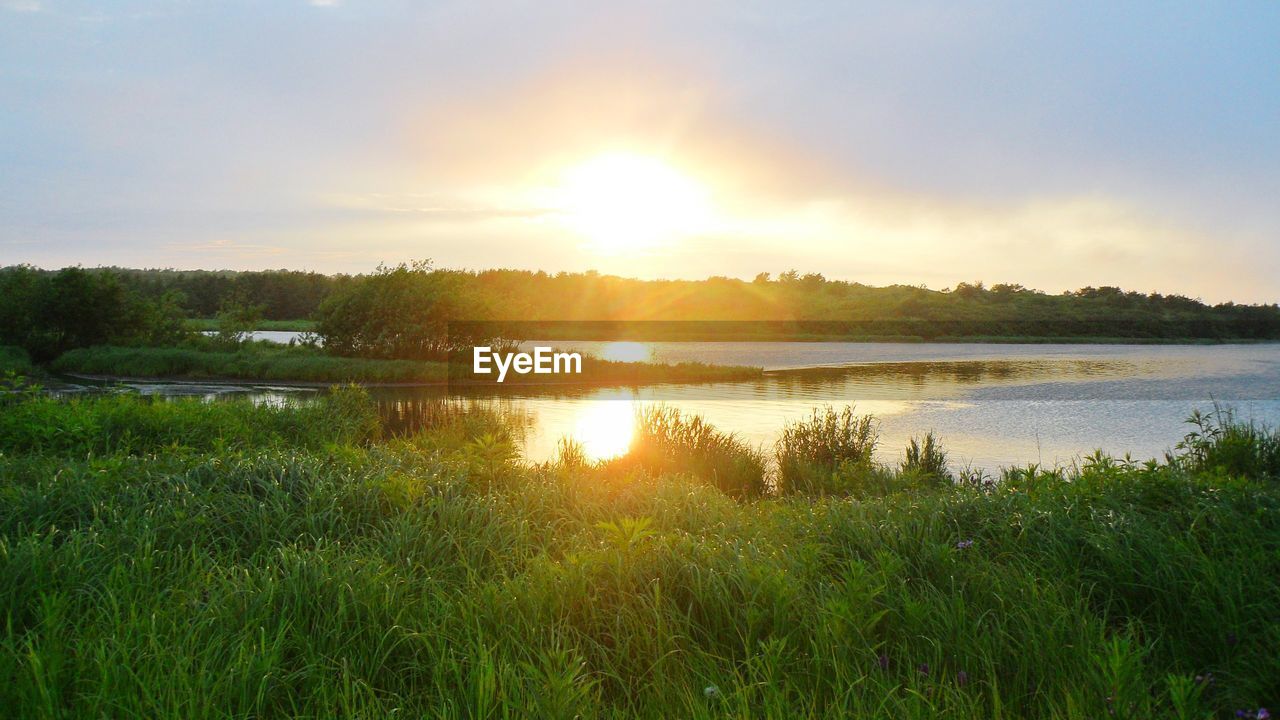 SCENIC VIEW OF LAKE DURING SUNSET