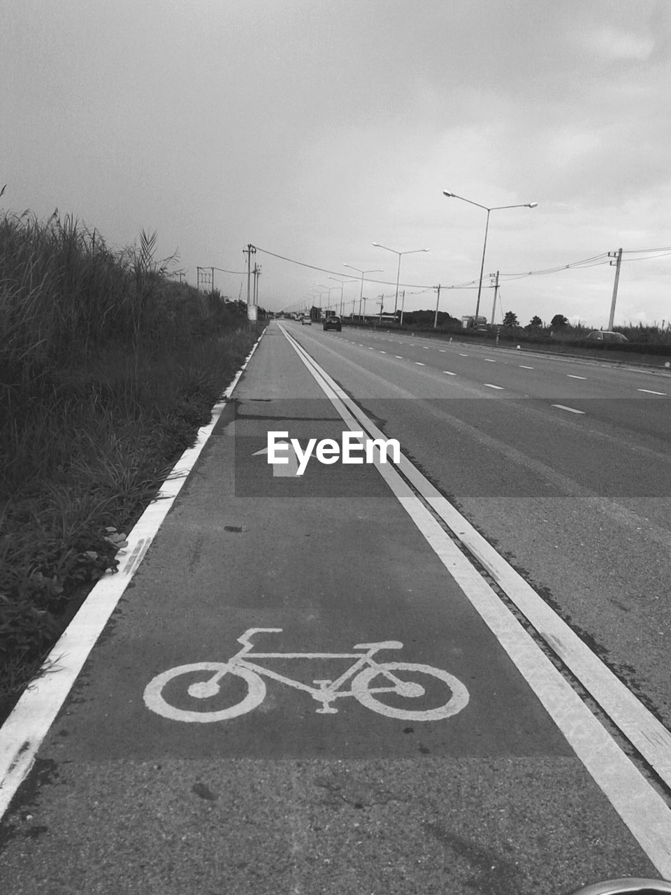 Bicycle lane on road against sky