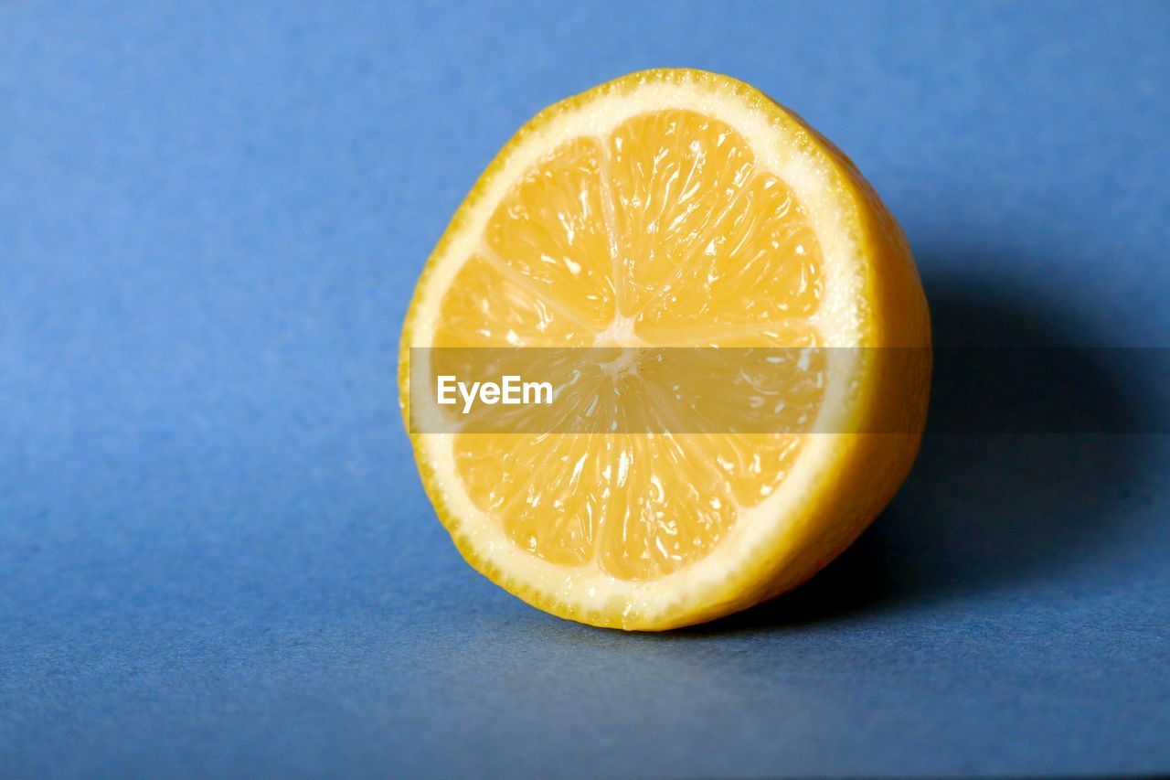 Close-up of lime against blue table