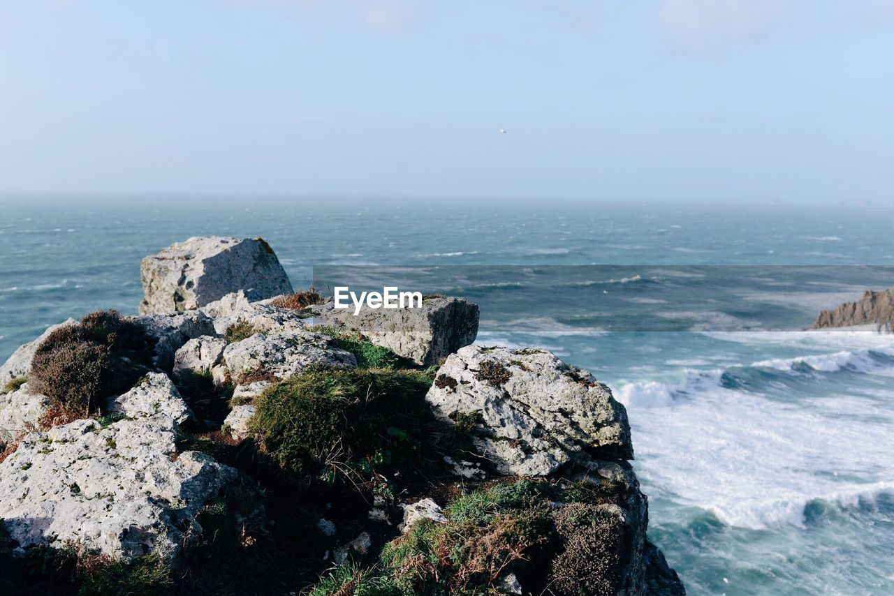 SCENIC VIEW OF SEA BY CLIFF AGAINST SKY