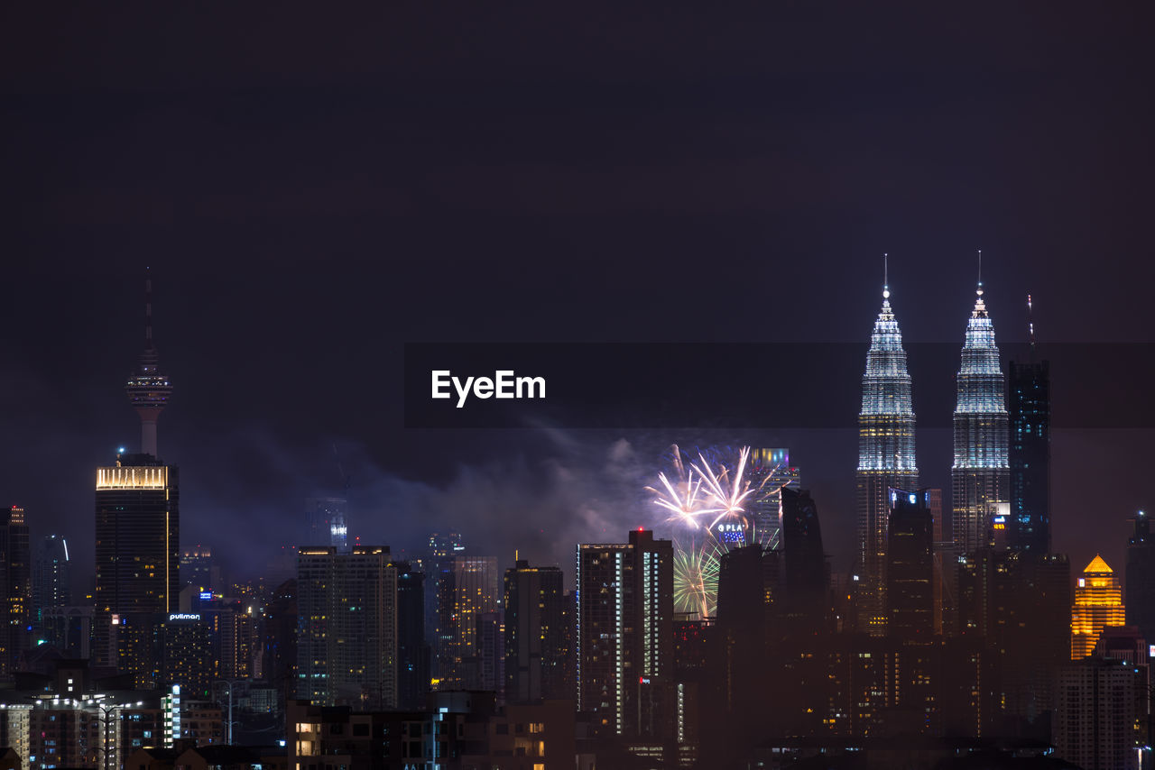 VIEW OF ILLUMINATED CITY AT NIGHT