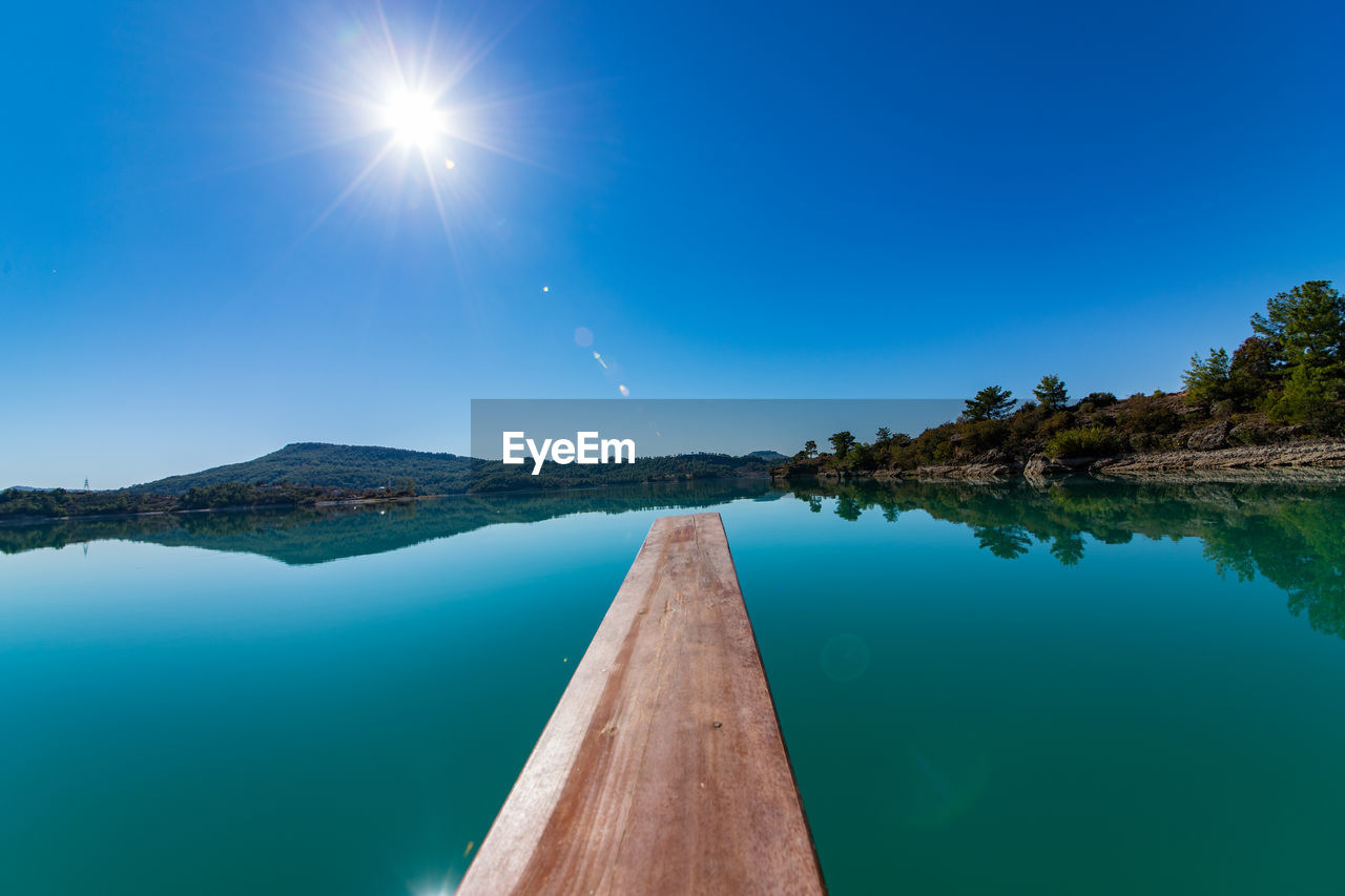 Scenic view of lake against blue sky