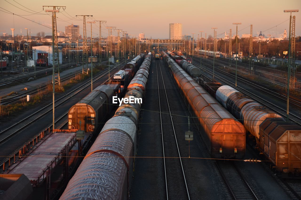 High angle view of freight trains at shunting yard during sunset