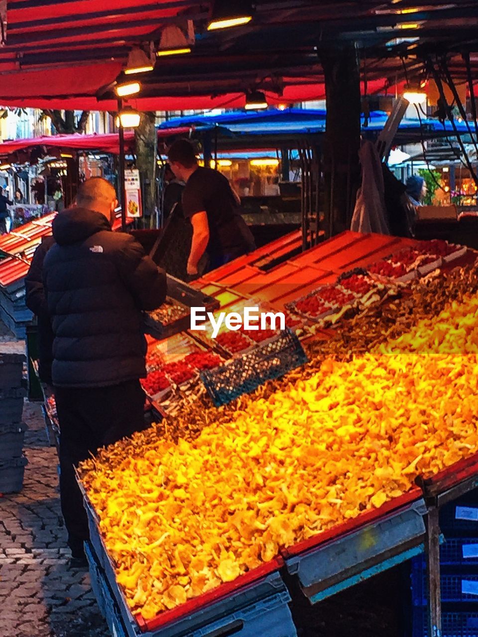 PEOPLE AT MARKET STALL AT NIGHT