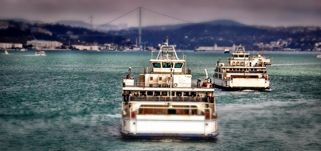 BOATS MOORED IN SEA