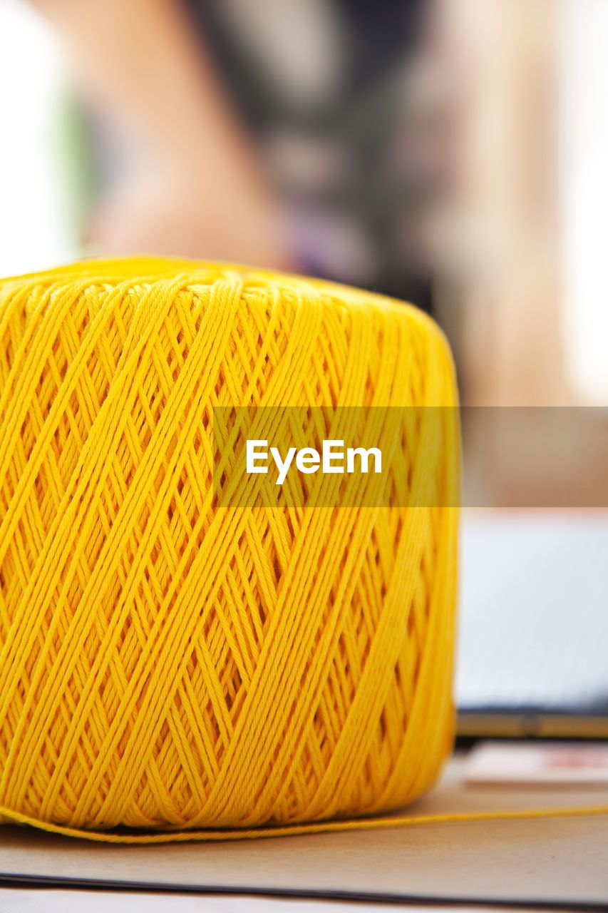 CLOSE-UP OF YELLOW AND BOOK ON TABLE