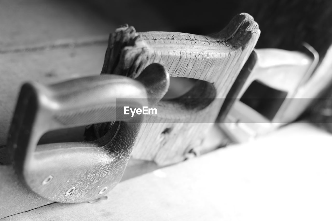 Close-up of hand saws in plank