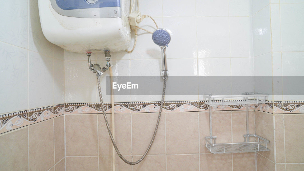 bathroom, shower, plumbing fixture, floor, indoors, room, flooring, no people, home, tile, sink, white, wall, wall - building feature, domestic room