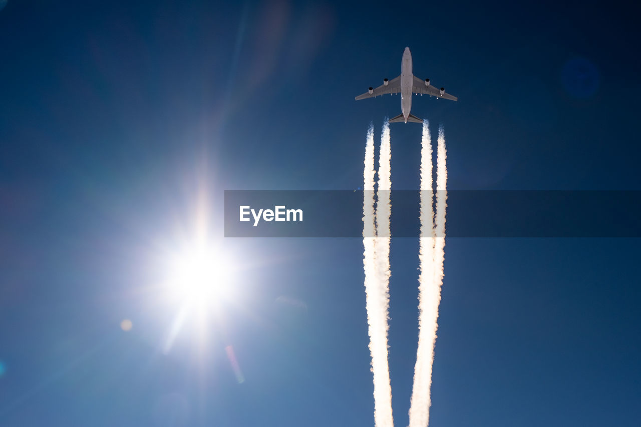 Low angle view of airplane flying against sky