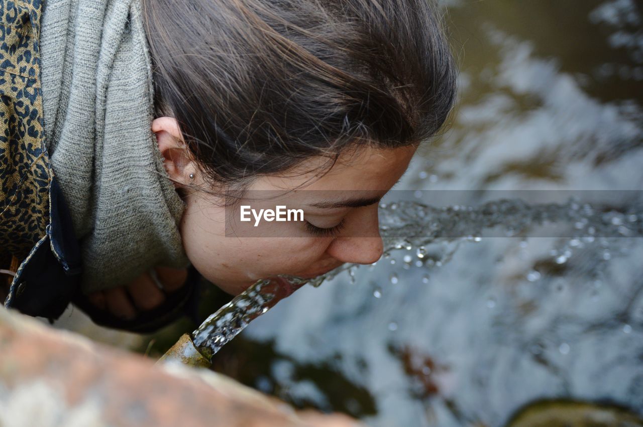 Close-up of woman drinking water