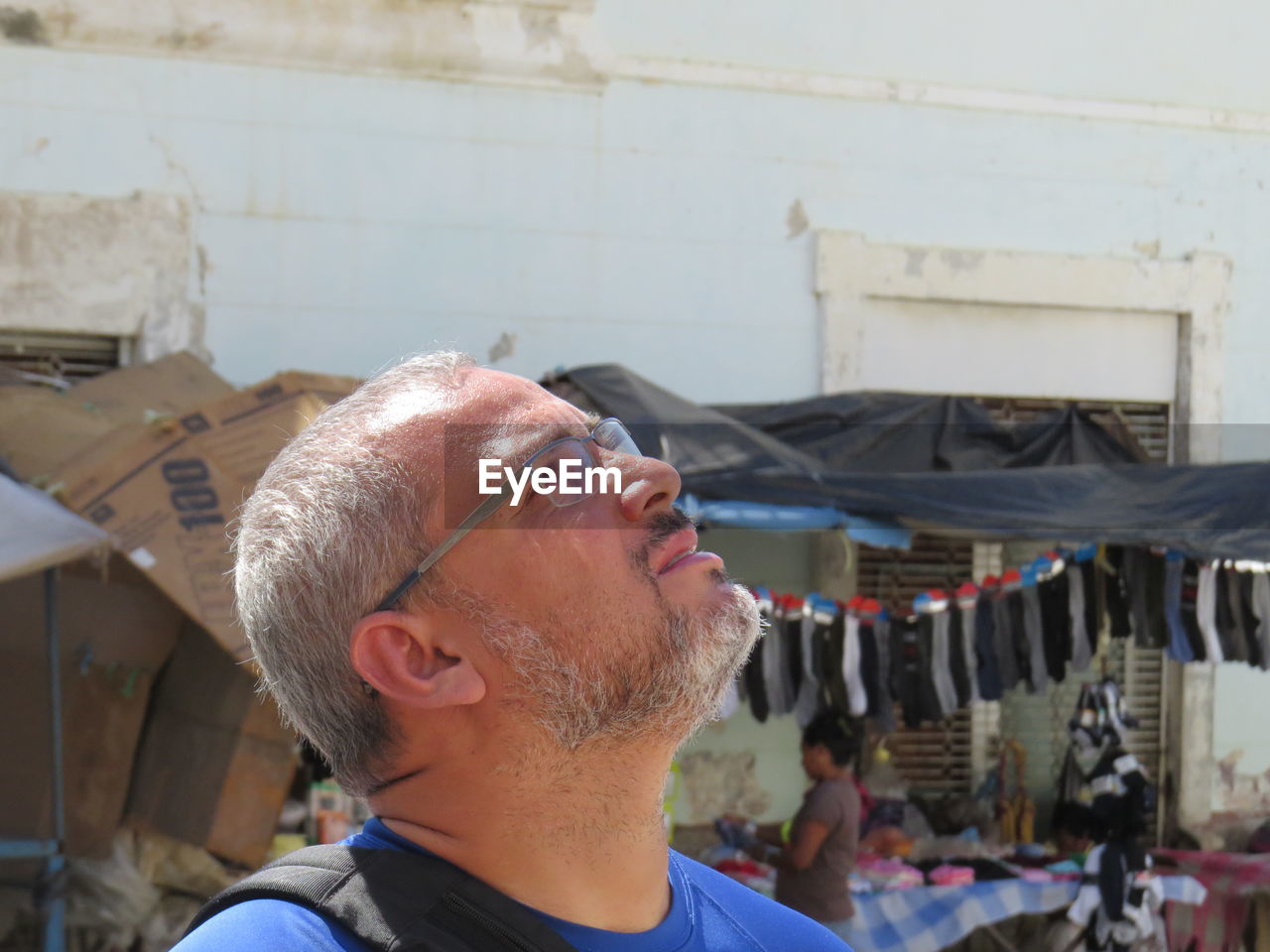 Mature man looking up at market