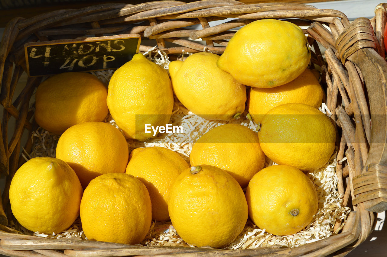 Fresh yellow lemons in a basket foe sale