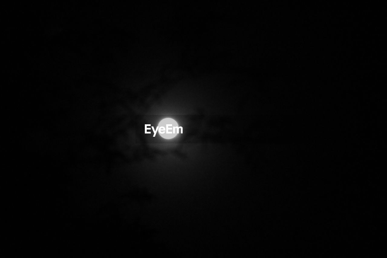 LOW ANGLE VIEW OF MOON IN THE DARK