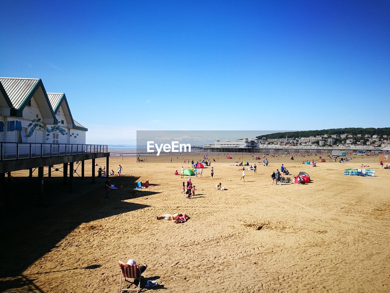 People on beach against clear sky