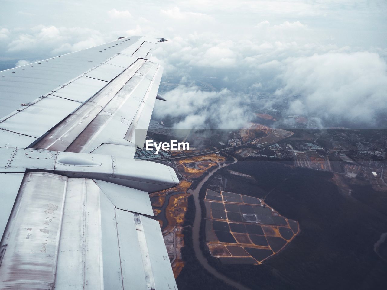 Cropped image of airplane flying over landscape