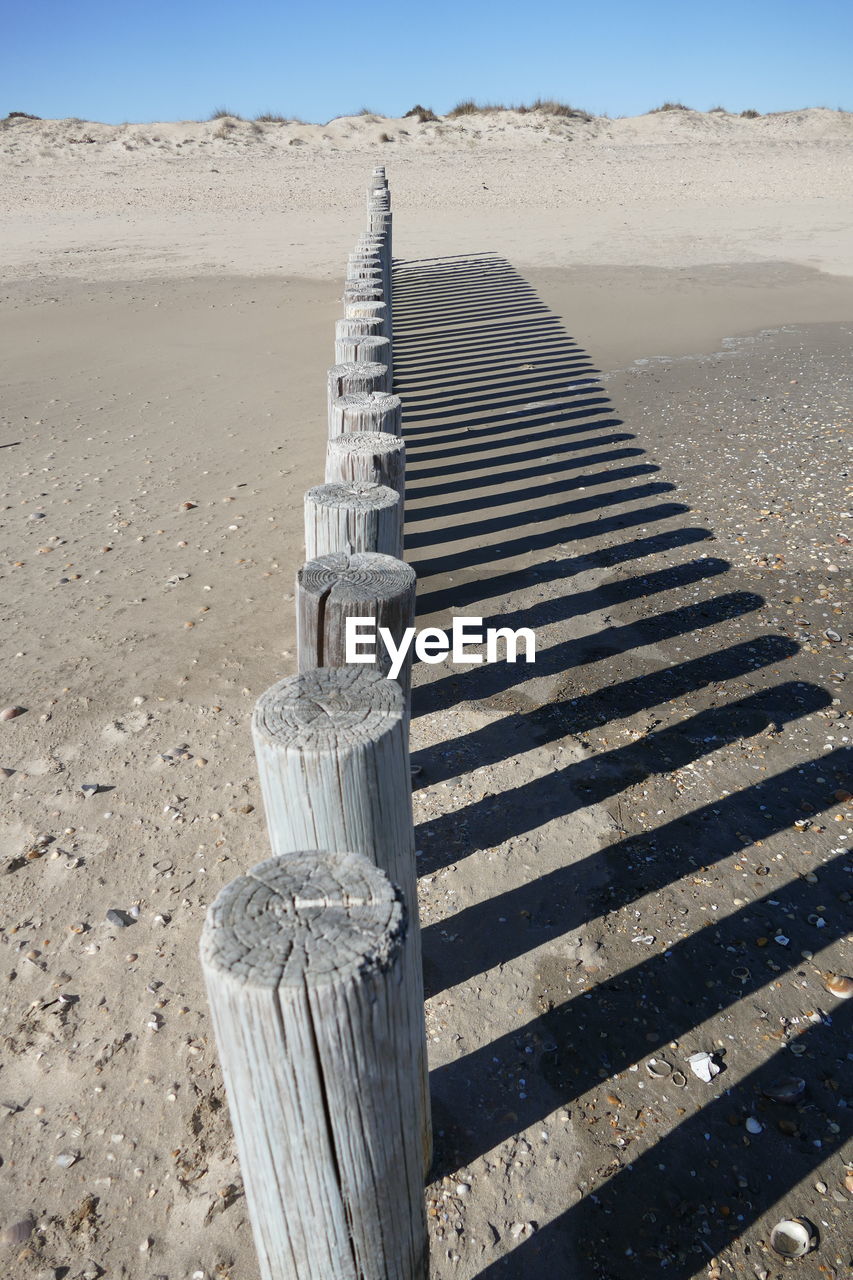 High angle view of wooden post on sand