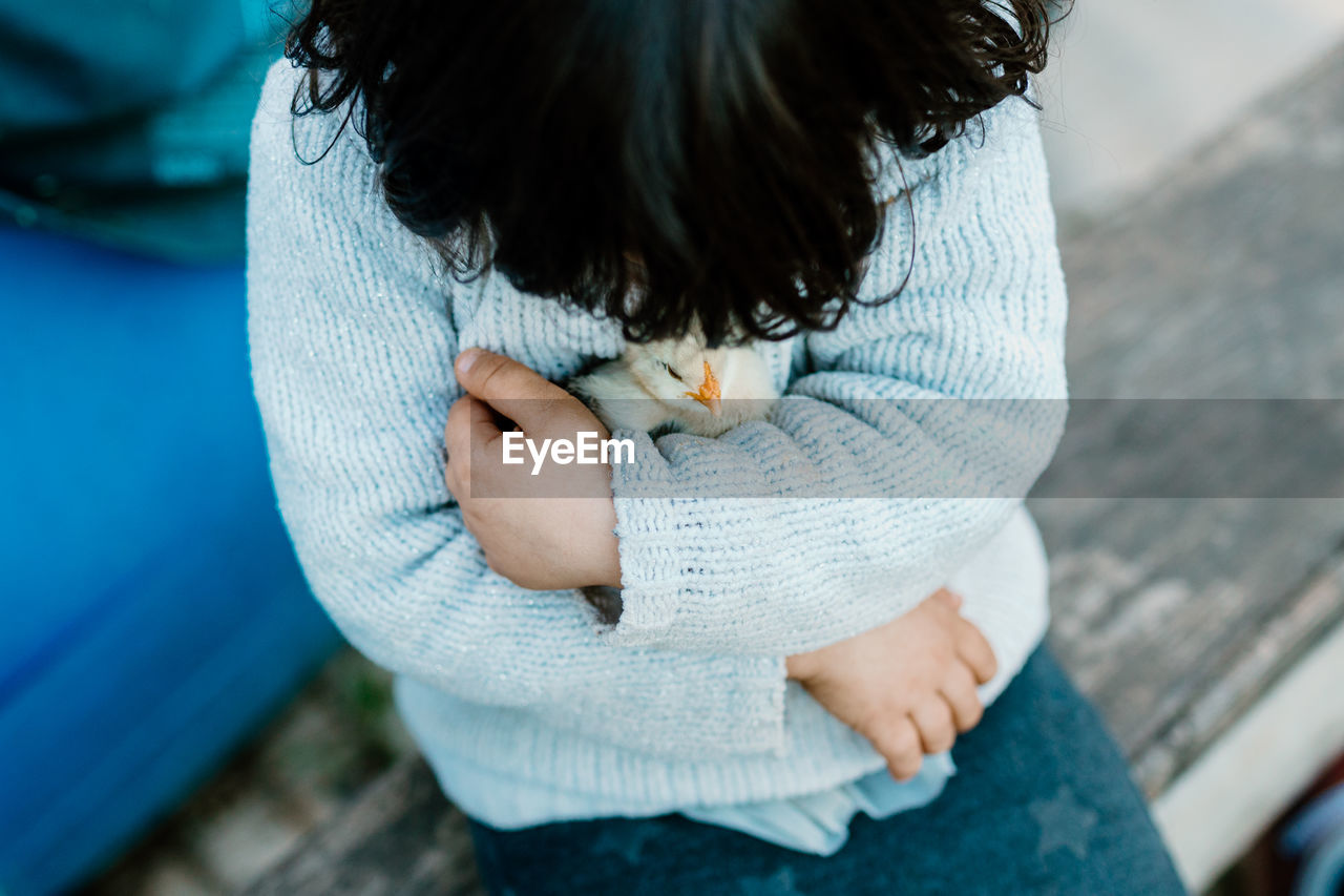 Child holding chick