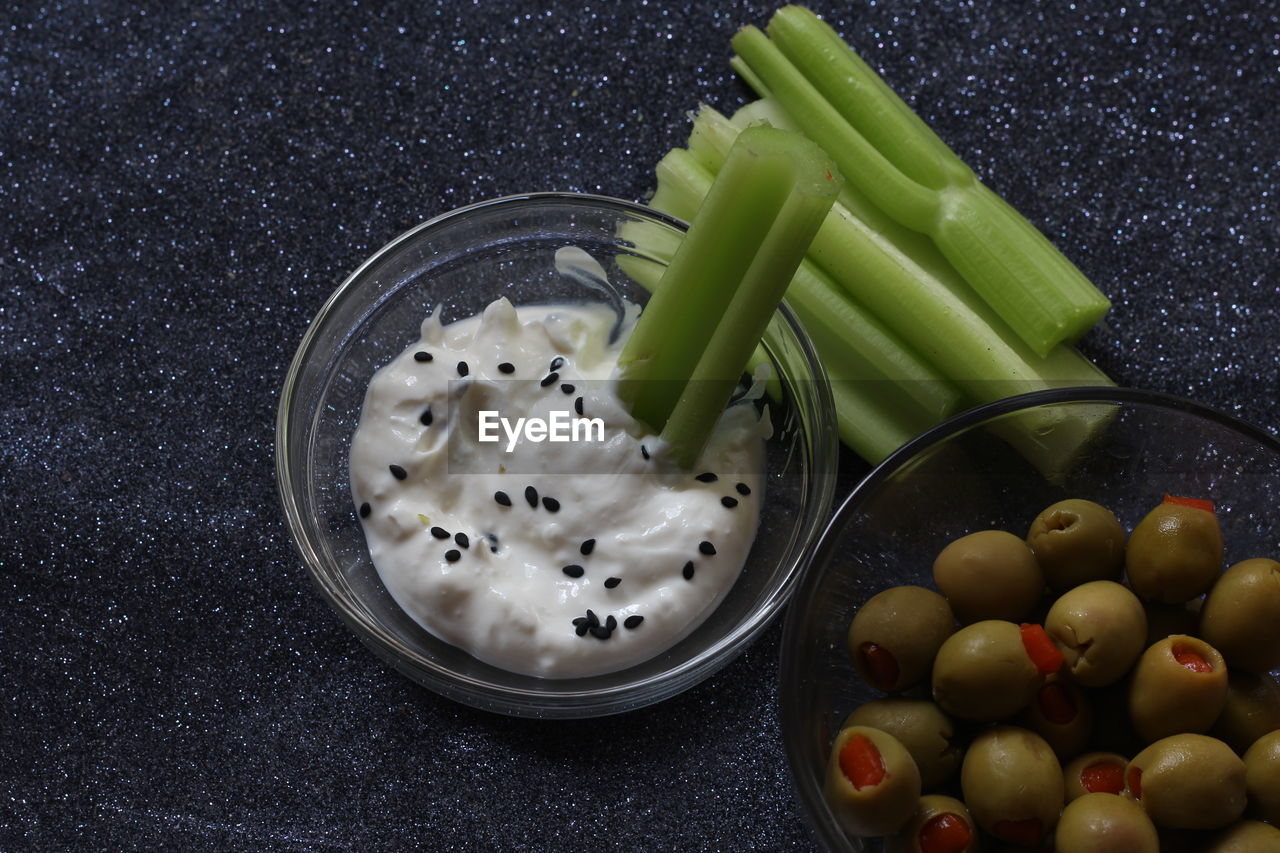 High angle view of vegetables with dip in bowl