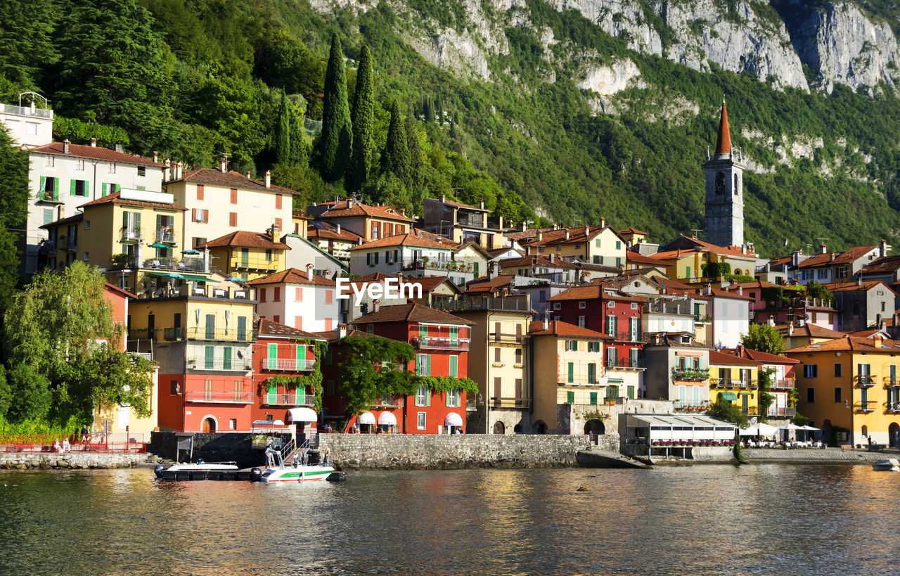 Calm lake against built structures on landscape